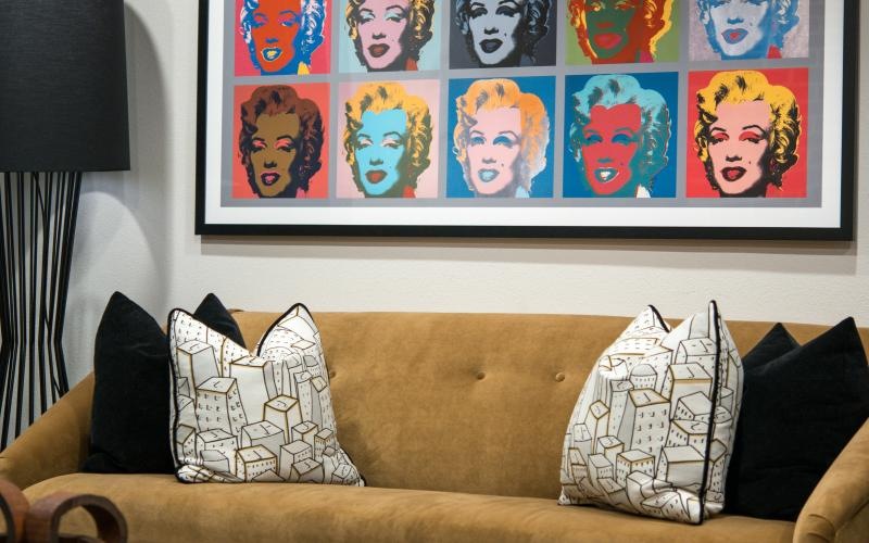a couch with a picture on the wall above it