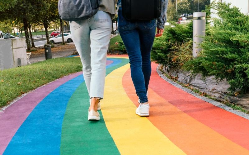 a pair of people walking on a colorful path