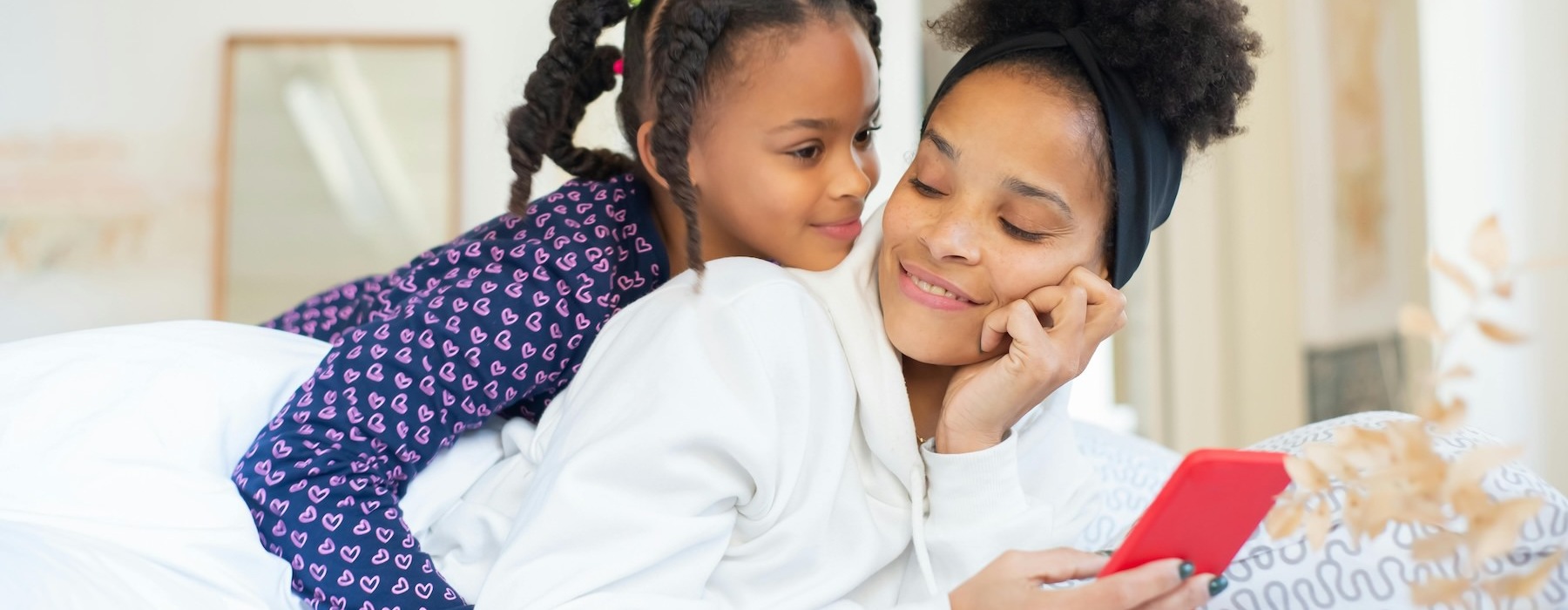a person and a child looking at a phone