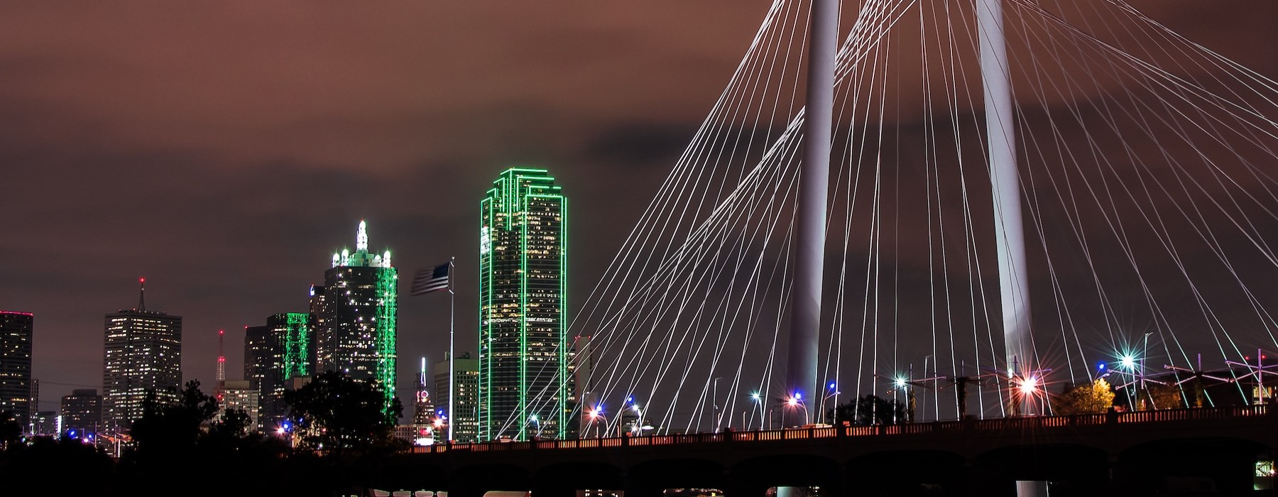 a city at night with a bridge